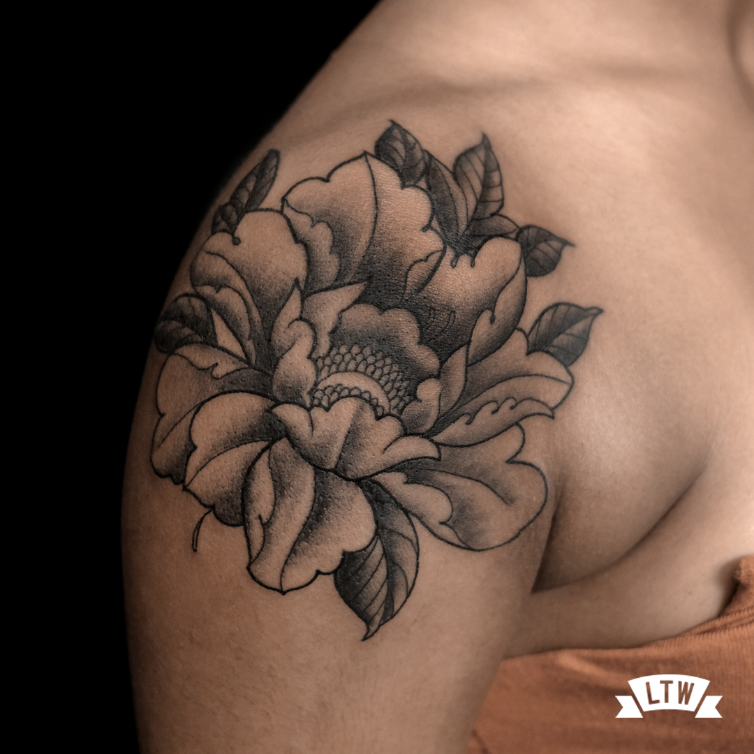Peony on a shoulder tattooed by Alexis