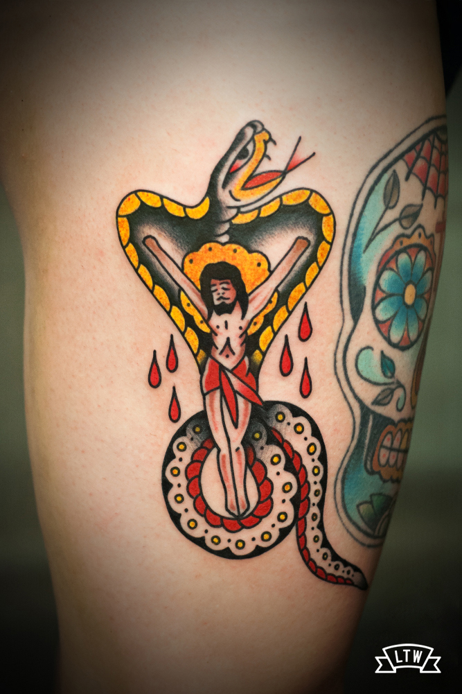 Traditional tattoo of Jesus Crist on a cobra by Javier Rodríguez
