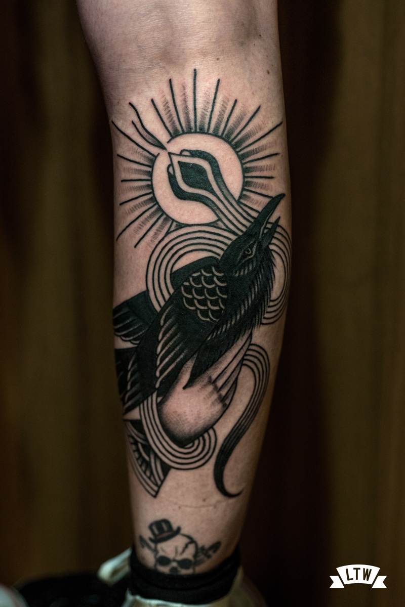 Crow with snake in black and grey done by Dennis