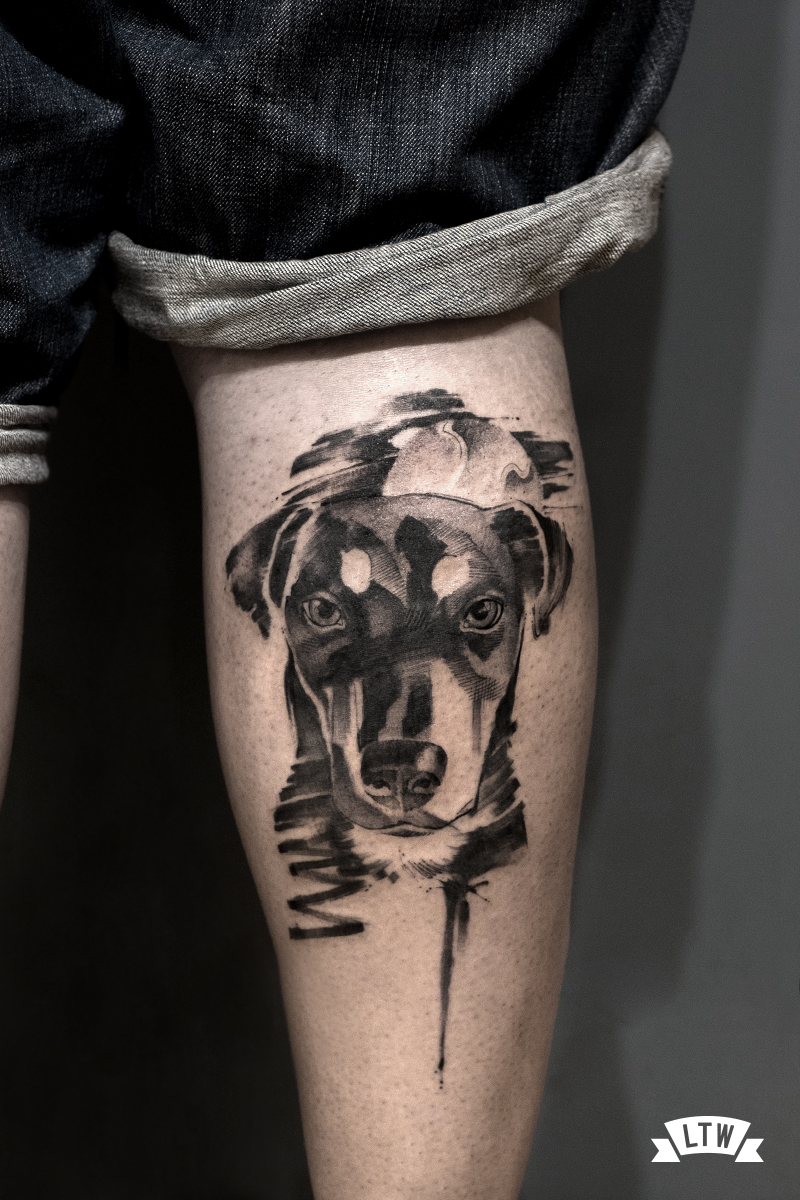 Dog tattooed by Man in black and grey
