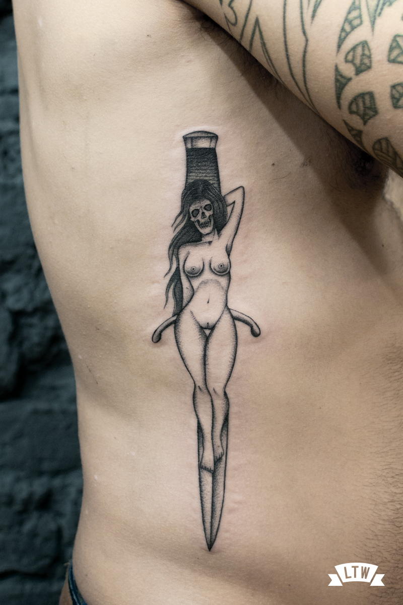 Knife and woman tattooed by Dani Cobra