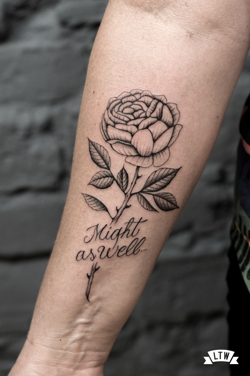 Flower tattooed with a lettering by Dani Cobra