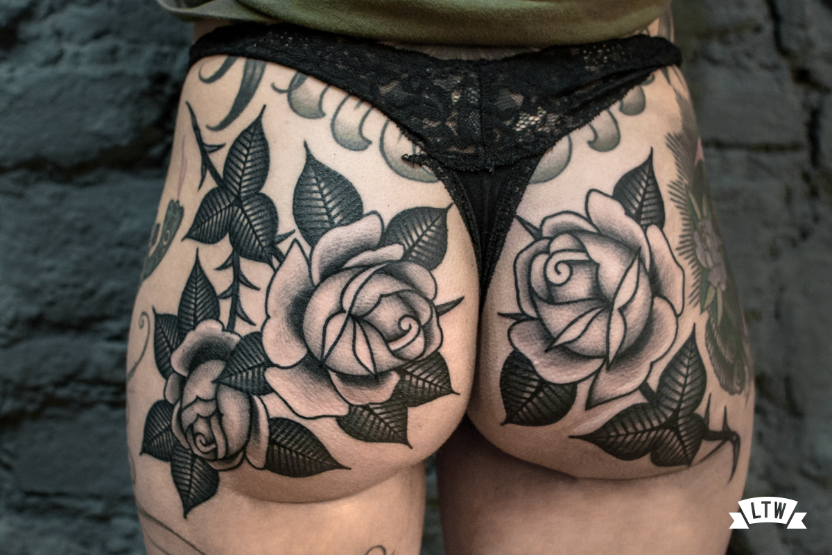 Roses tattooed in black and grey by Dennis