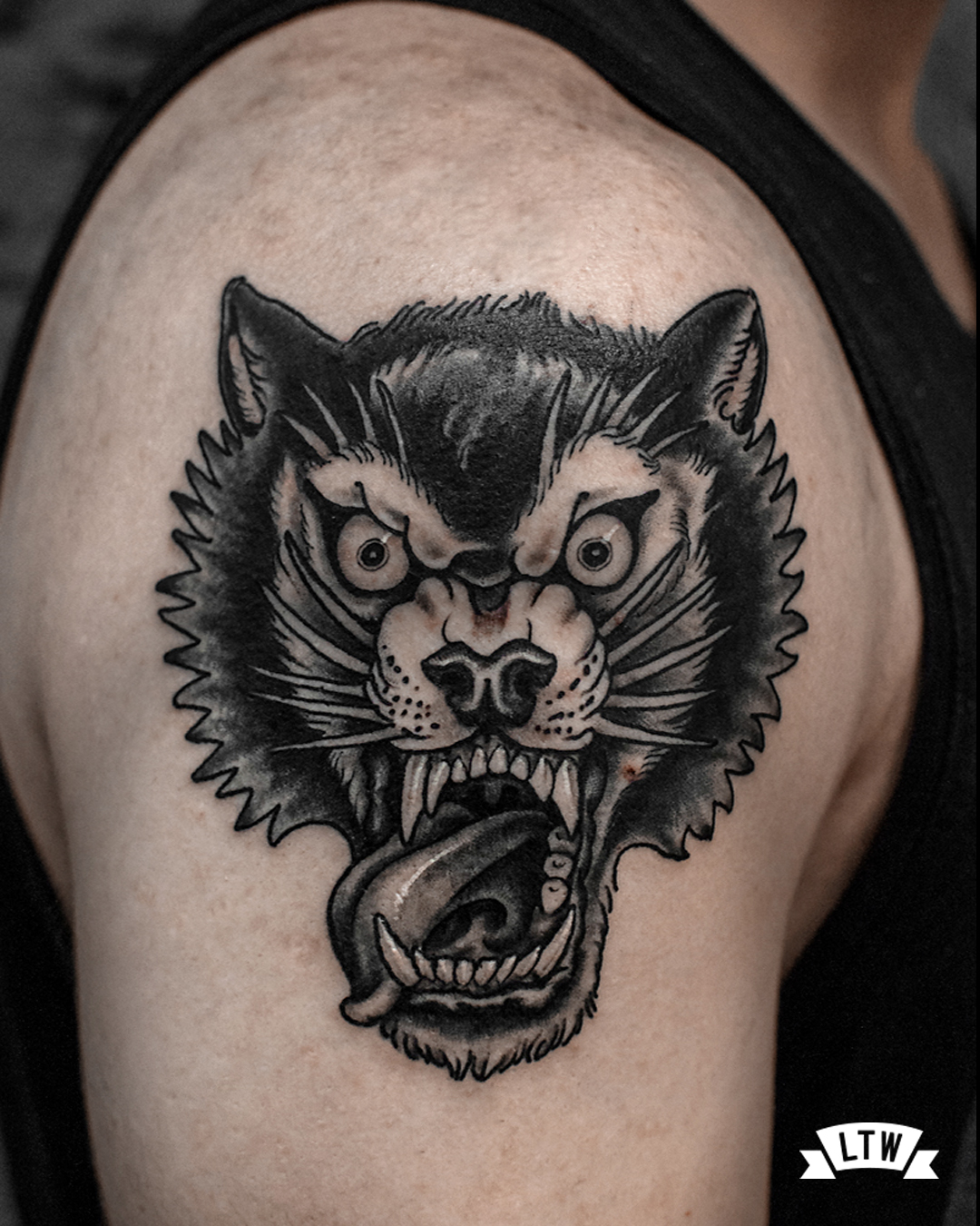 Wolf head tattooed by Rafa Serrano