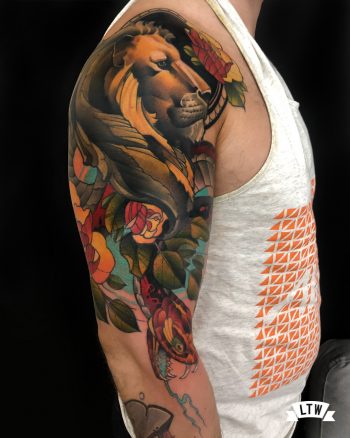 Lion with flowers tattooed in color by Jon Pall