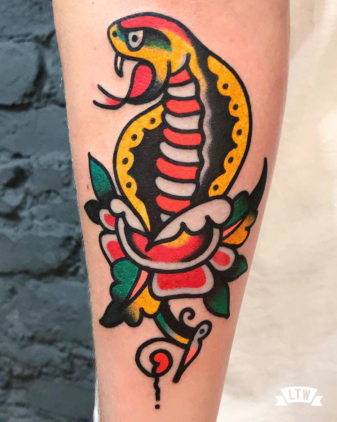 Cobra with rose tattooed by Javier Rodriguez