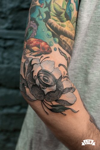 Flower tattooed on a elbow by Jon Pall
