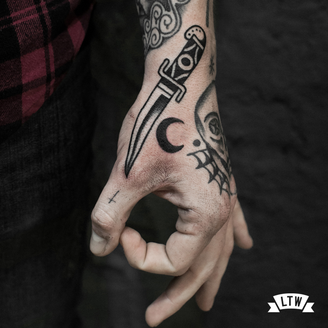 Dagger tattooed on a hand by Dennis