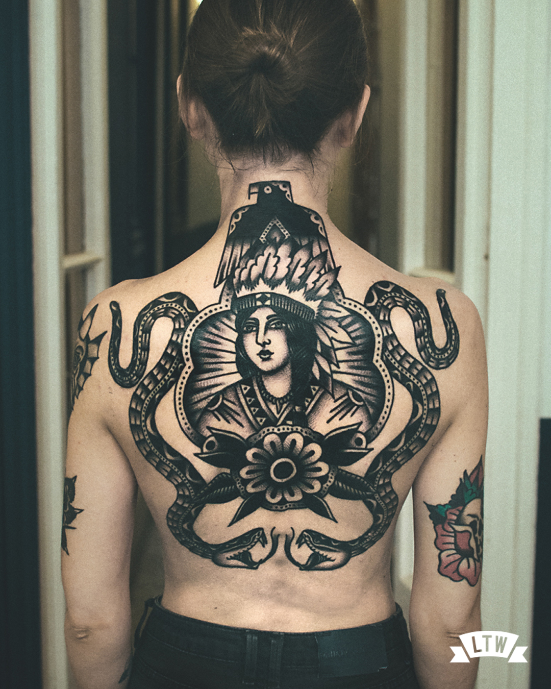 Back piece tattooed in black and white by Dennis