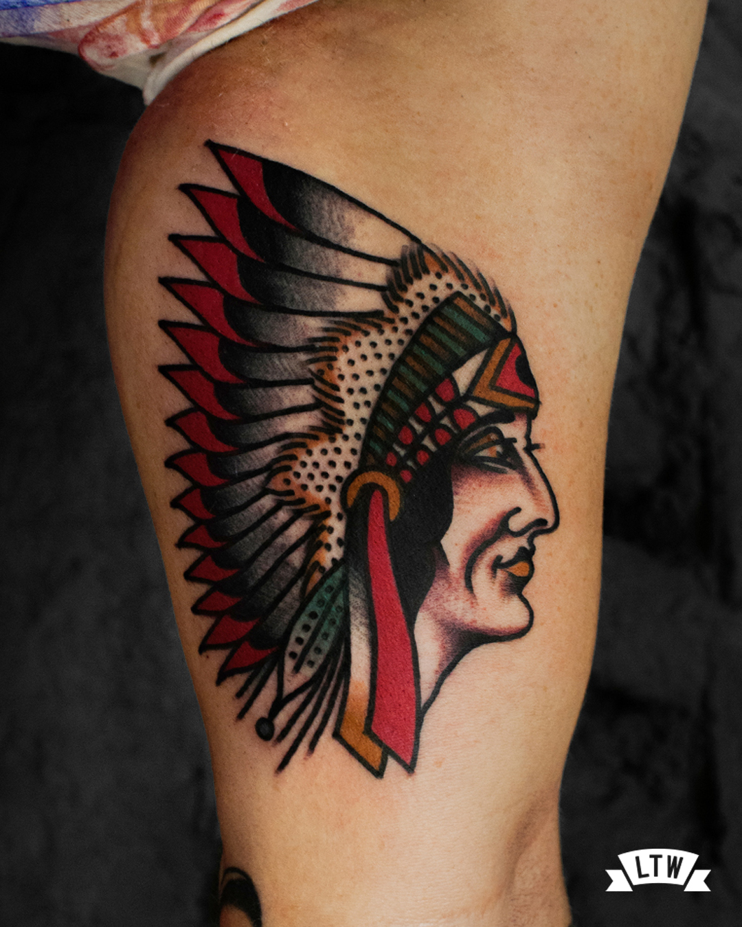 Native american tattooed on a biceps by Dennis