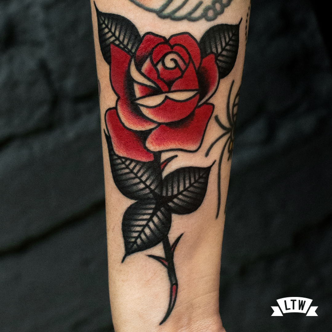Red rose tattooed by Dennis